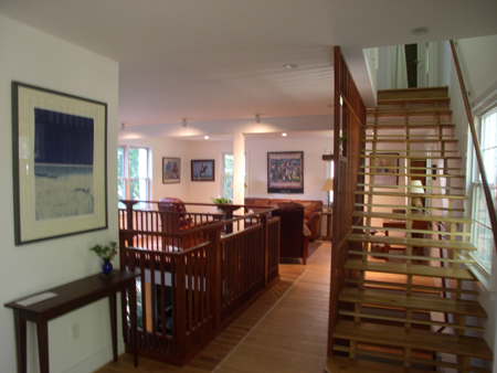 Entry looking toward the living room. At the left is the overlook to the dining/kitchen floor below